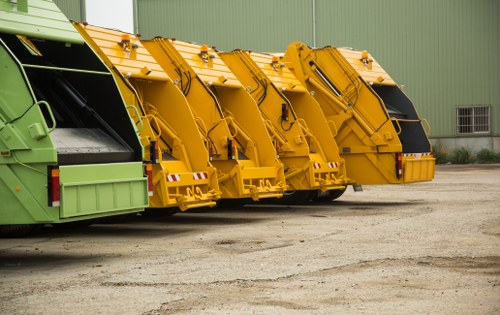 Fleet of commercial waste vehicles parked at depot
